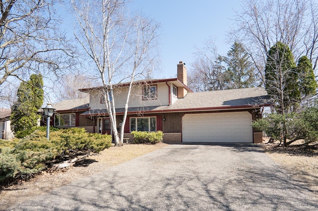 7740 Arlington Ave N, Brooklyn Park, MN 55443 - traditional-style house featuring an attached garage, driveway, and a chimney