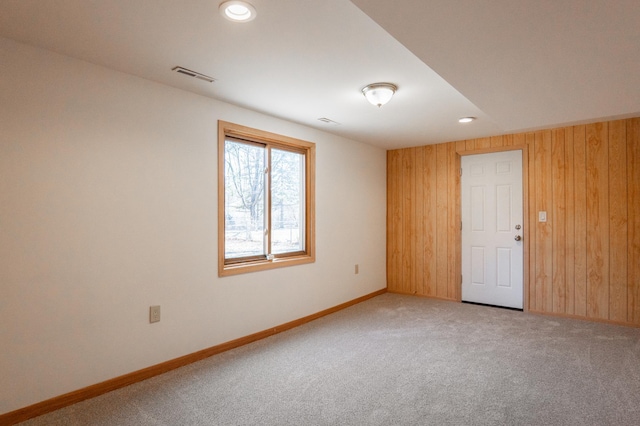 7740 Arlington Ave N, Brooklyn Park, MN 55443 - spare room with wood walls, baseboards, visible vents, and carpet floors