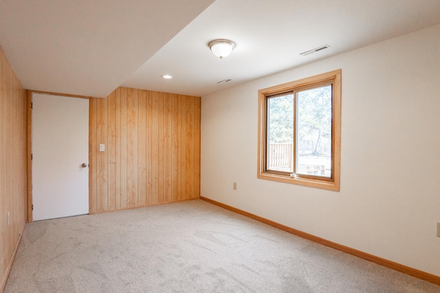 7740 Arlington Ave N, Brooklyn Park, MN 55443 - empty room featuring wooden walls, baseboards, carpet, and visible vents