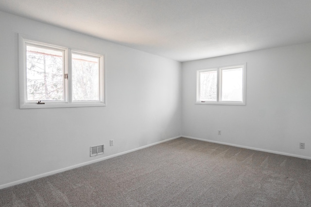 7740 Arlington Ave N, Brooklyn Park, MN 55443 - carpeted spare room with baseboards and visible vents