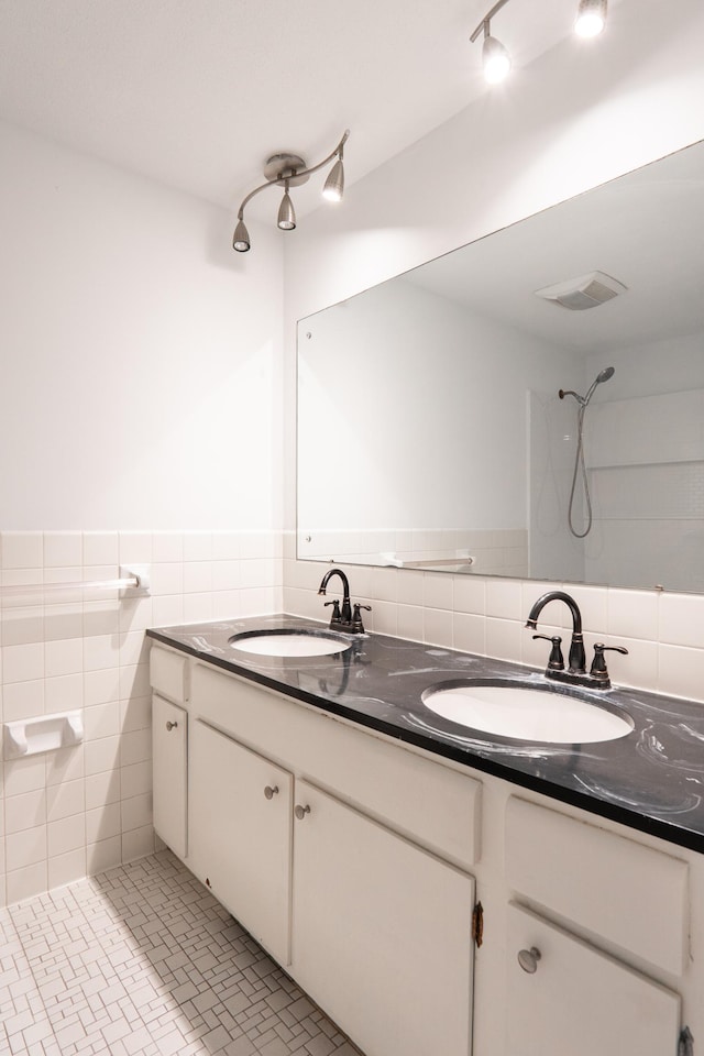 7740 Arlington Ave N, Brooklyn Park, MN 55443 - bathroom featuring visible vents, a sink, and double vanity