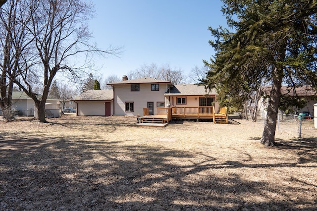 7740 Arlington Ave N, Brooklyn Park, MN 55443 - back of property featuring fence, a wooden deck, and a chimney