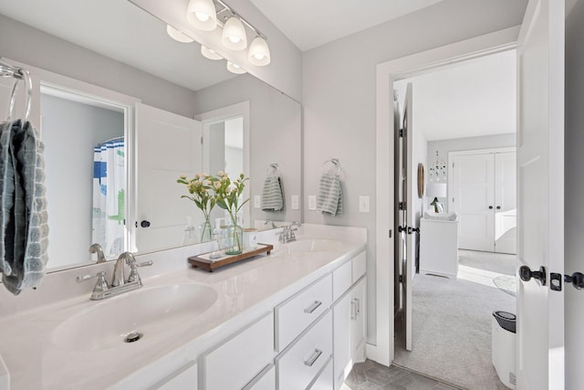 full bath with a sink and double vanity