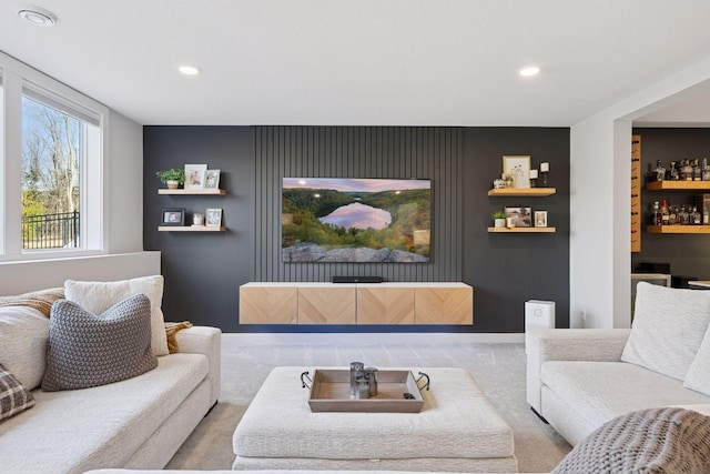 carpeted living area featuring a bar and recessed lighting