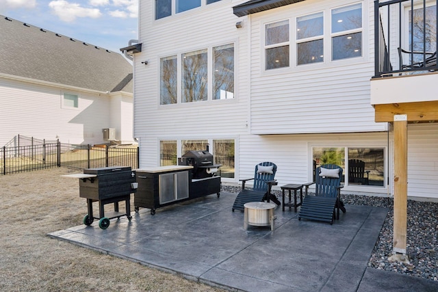view of patio / terrace with fence and a grill