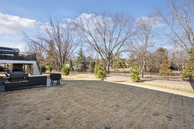 view of yard featuring stairs, a wooden deck, and fence
