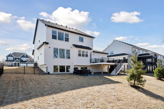rear view of property featuring stairs, a deck, fence private yard, and a patio