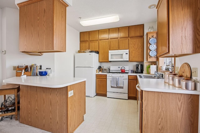 907 Fairfield Way, Minnetonka, MN 55305 - kitchen featuring white appliances, a peninsula, light countertops, and brown cabinetry