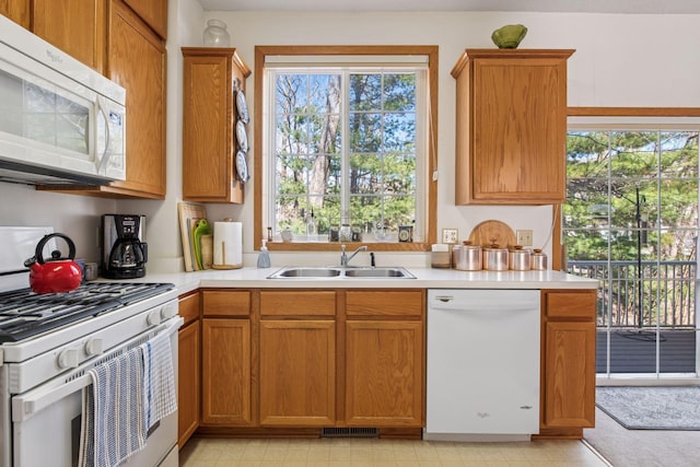907 Fairfield Way, Minnetonka, MN 55305 - kitchen featuring white appliances, light countertops, and brown cabinets