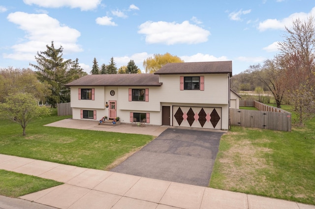 1602 River St, Monticello, MN 55362 - split foyer home with an attached garage, asphalt driveway, and a gate