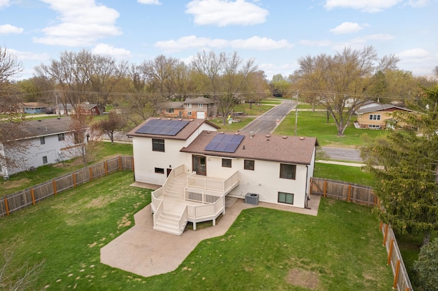 1602 River St, Monticello, MN 55362 - rear view of house with a patio area, roof mounted solar panels, a deck, central air condition unit, and stairway