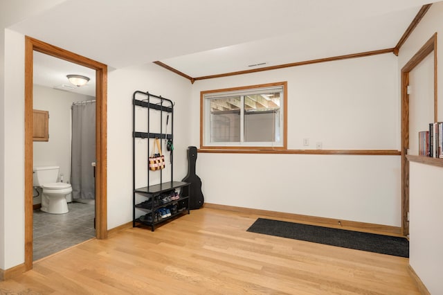 1602 River St, Monticello, MN 55362 - spare room with wood finished floors, baseboards, and ornamental molding