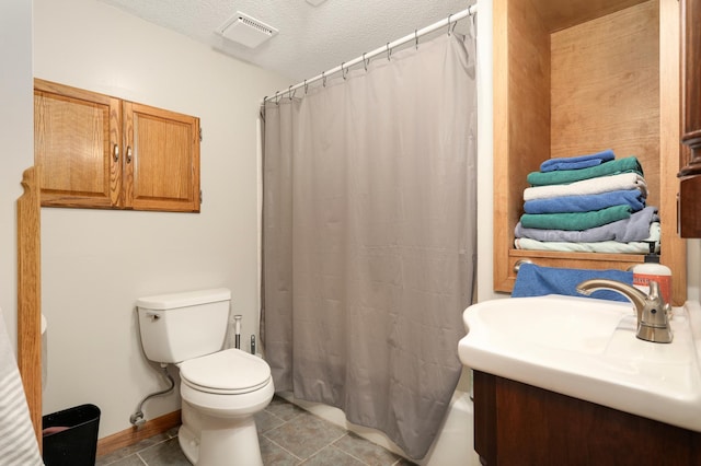 1602 River St, Monticello, MN 55362 - bathroom featuring toilet, tile patterned flooring, a textured ceiling, and a sink