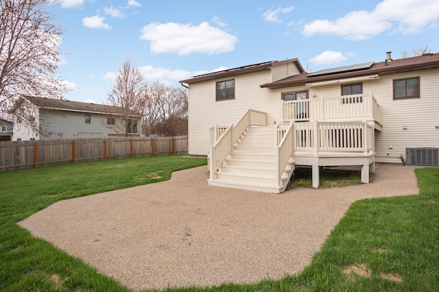 1602 River St, Monticello, MN 55362 - back of property with roof mounted solar panels, cooling unit, stairway, and a wooden deck