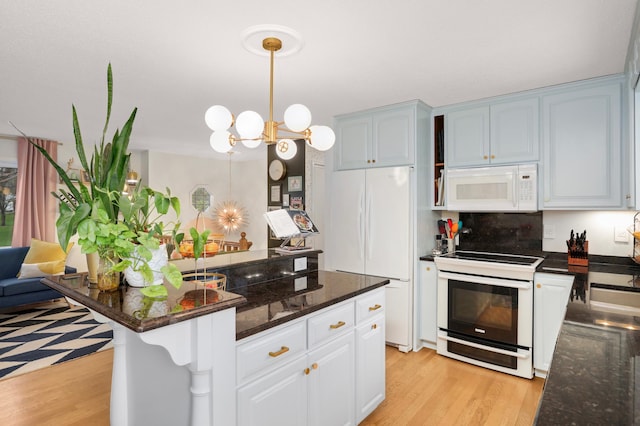 1602 River St, Monticello, MN 55362 - kitchen featuring white appliances, light wood-style flooring, a chandelier, pendant lighting, and dark stone counters