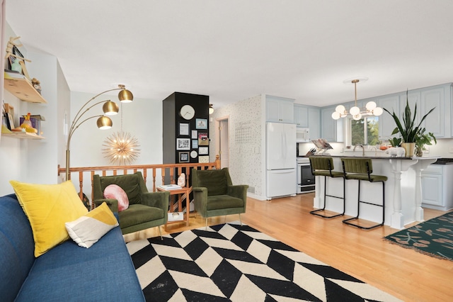 1602 River St, Monticello, MN 55362 - living room featuring a chandelier and light wood-style floors