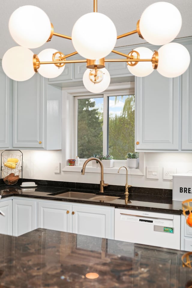 1602 River St, Monticello, MN 55362 - kitchen with a sink, white dishwasher, white cabinetry, and dark stone counters
