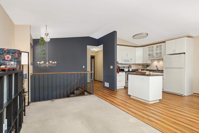 2628 Sumac Ct, White Bear Lake, MN 55110 - kitchen featuring white appliances, vaulted ceiling, white cabinets, light wood-style floors, and dark countertops