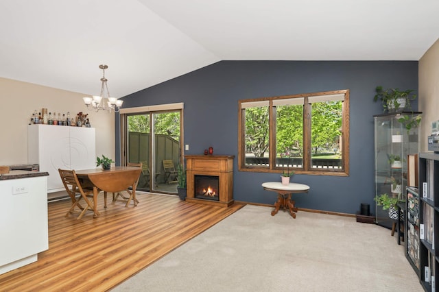 2628 Sumac Ct, White Bear Lake, MN 55110 - dining space featuring a chandelier, lofted ceiling, and wood finished floors