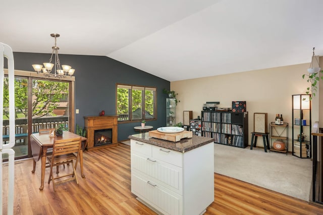 2628 Sumac Ct, White Bear Lake, MN 55110 - kitchen with white cabinets, light wood finished floors, lofted ceiling, a kitchen island, and a chandelier