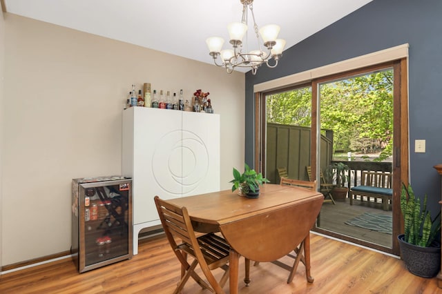 2628 Sumac Ct, White Bear Lake, MN 55110 - dining space with beverage cooler, light wood finished floors, and a chandelier