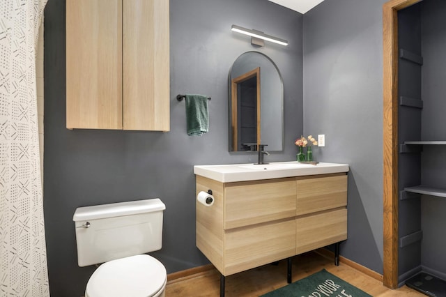 2628 Sumac Ct, White Bear Lake, MN 55110 - bathroom featuring vanity, toilet, a shower with shower curtain, baseboards, and wood finished floors