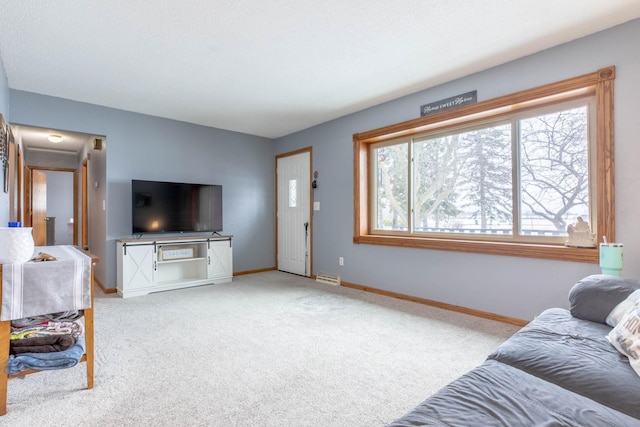 carpeted living area with baseboards