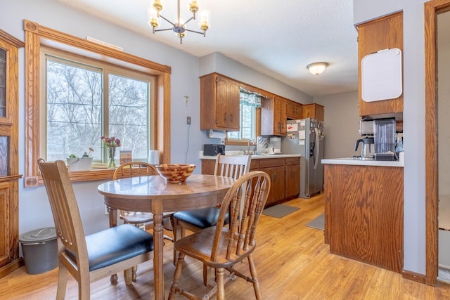 11378 230th St, Cold Spring, MN 56320 - dining room featuring light wood-style floors, a chandelier, and a textured ceiling