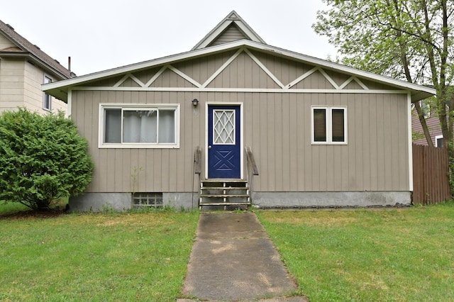 view of front of home with entry steps and a front lawn