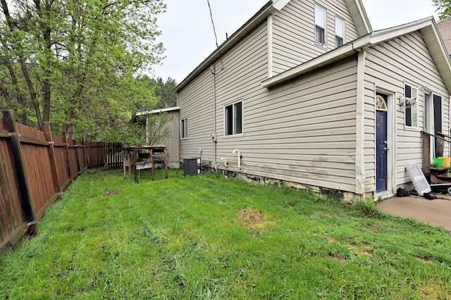 view of side of home with central AC unit