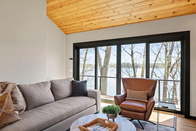 living area featuring a water view, wood finished floors, wooden ceiling, and vaulted ceiling
