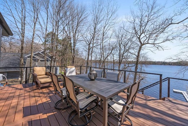 deck featuring a water view and outdoor dining area