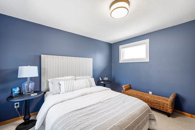 carpeted bedroom with baseboards and a textured ceiling