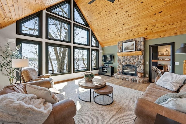living room with wooden ceiling, high vaulted ceiling, a fireplace, and wood finished floors