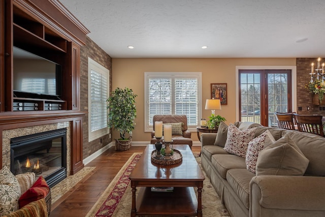 2834 12th Ave NW, Austin, MN 55912 - living room featuring wood finished floors, baseboards, a high end fireplace, a textured ceiling, and recessed lighting