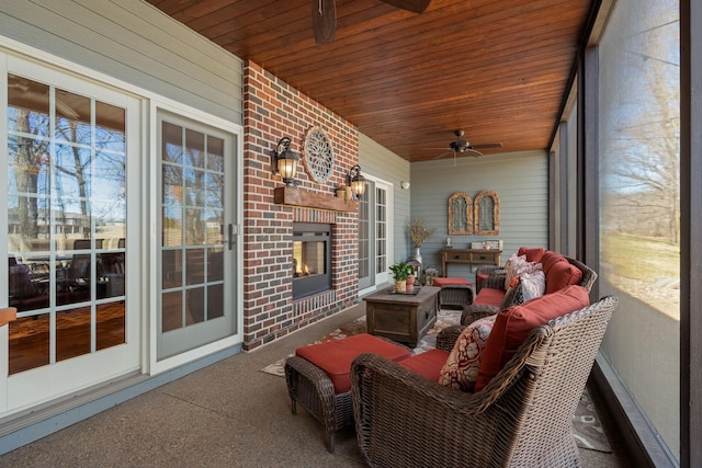 2834 12th Ave NW, Austin, MN 55912 - sunroom / solarium featuring a ceiling fan and an outdoor living space with a fireplace