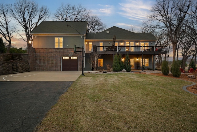 2834 12th Ave NW, Austin, MN 55912 - view of front facade with asphalt driveway, a front lawn, brick siding, an attached garage, and a deck