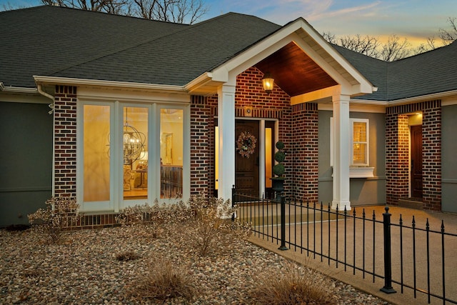 2834 12th Ave NW, Austin, MN 55912 - view of front of property featuring brick siding, fence, and a shingled roof