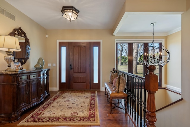 2834 12th Ave NW, Austin, MN 55912 - foyer featuring a chandelier, wood finished floors, and baseboards