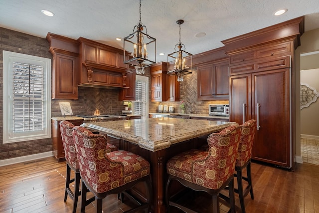 2834 12th Ave NW, Austin, MN 55912 - kitchen featuring baseboards, dark wood-style flooring, a sink, and recessed lighting