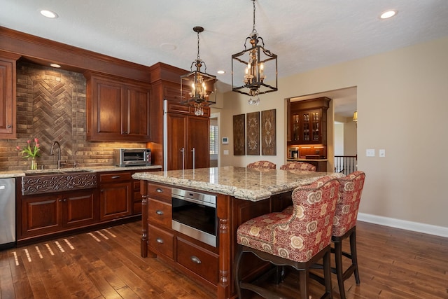 2834 12th Ave NW, Austin, MN 55912 - kitchen featuring a sink, decorative backsplash, a chandelier, dark wood finished floors, and recessed lighting