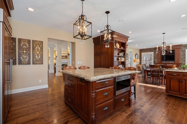 2834 12th Ave NW, Austin, MN 55912 - kitchen with decorative columns, a chandelier, open shelves, dark wood-type flooring, and decorative light fixtures