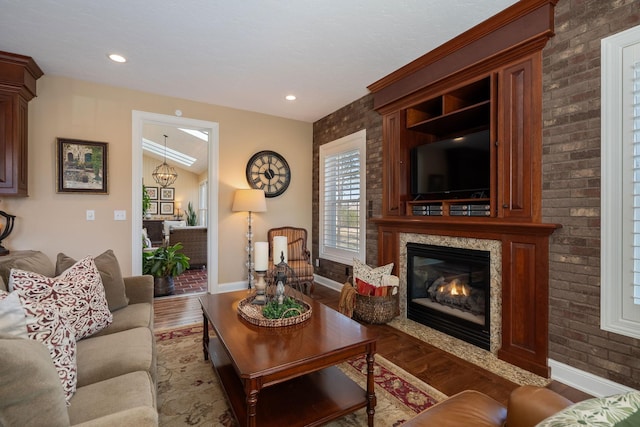 2834 12th Ave NW, Austin, MN 55912 - living room featuring wood finished floors, baseboards, a glass covered fireplace, and recessed lighting