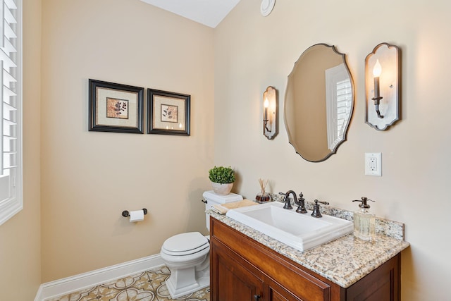 2834 12th Ave NW, Austin, MN 55912 - half bath featuring toilet, vanity, baseboards, and tile patterned floors