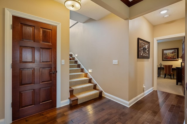 2834 12th Ave NW, Austin, MN 55912 - entryway featuring dark wood-type flooring, baseboards, and stairs