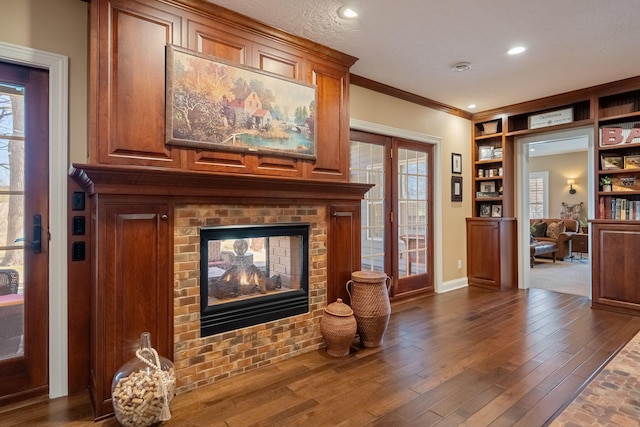 2834 12th Ave NW, Austin, MN 55912 - living area featuring a fireplace, baseboards, built in features, crown molding, and plenty of natural light