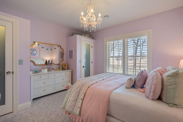 2834 12th Ave NW, Austin, MN 55912 - bedroom with a chandelier, light carpet, and baseboards