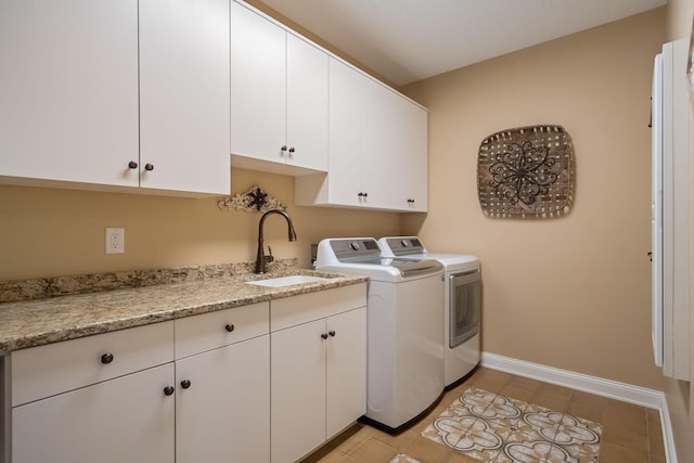 2834 12th Ave NW, Austin, MN 55912 - laundry room featuring independent washer and dryer, cabinet space, baseboards, and light tile patterned flooring