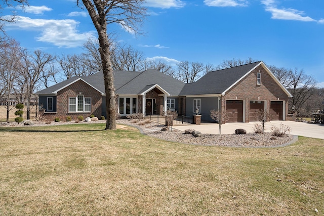 2834 12th Ave NW, Austin, MN 55912 - view of front facade with brick siding, driveway, a front yard, and an attached garage