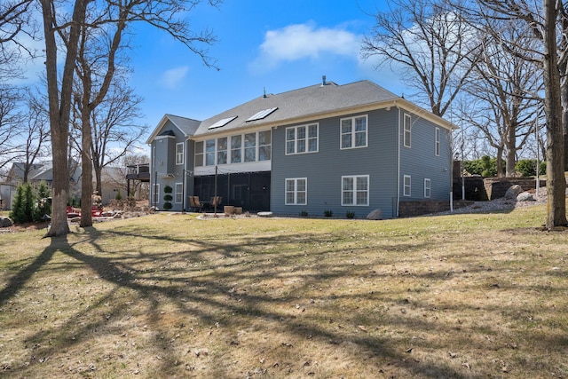 2834 12th Ave NW, Austin, MN 55912 - rear view of property with a sunroom and a lawn